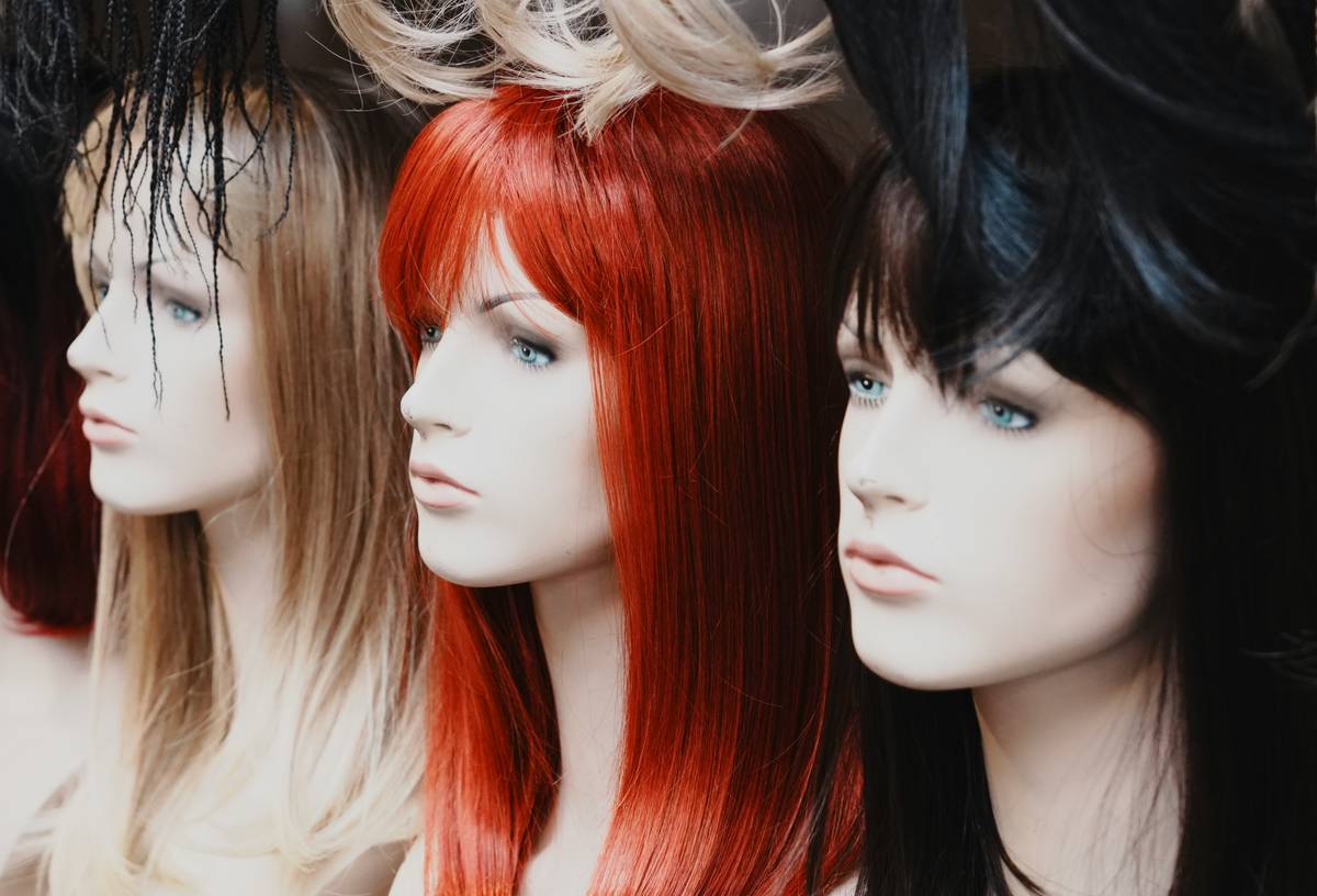 A woman wearing a vibrant gele-style cultural hair wrap