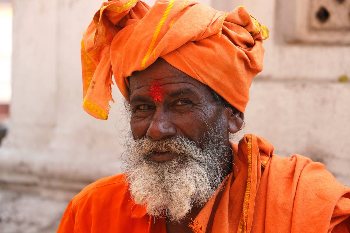 A display of various heritage hair wraps in different fabrics, colors, and sizes.