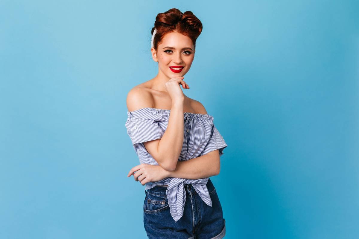 a woman posing for a picture with her hand on her chin