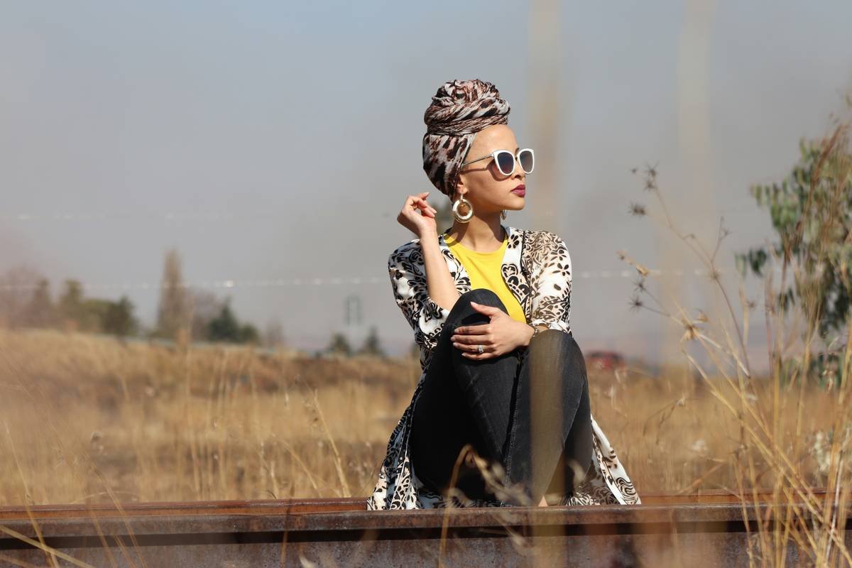 A woman sitting on top of a train track
