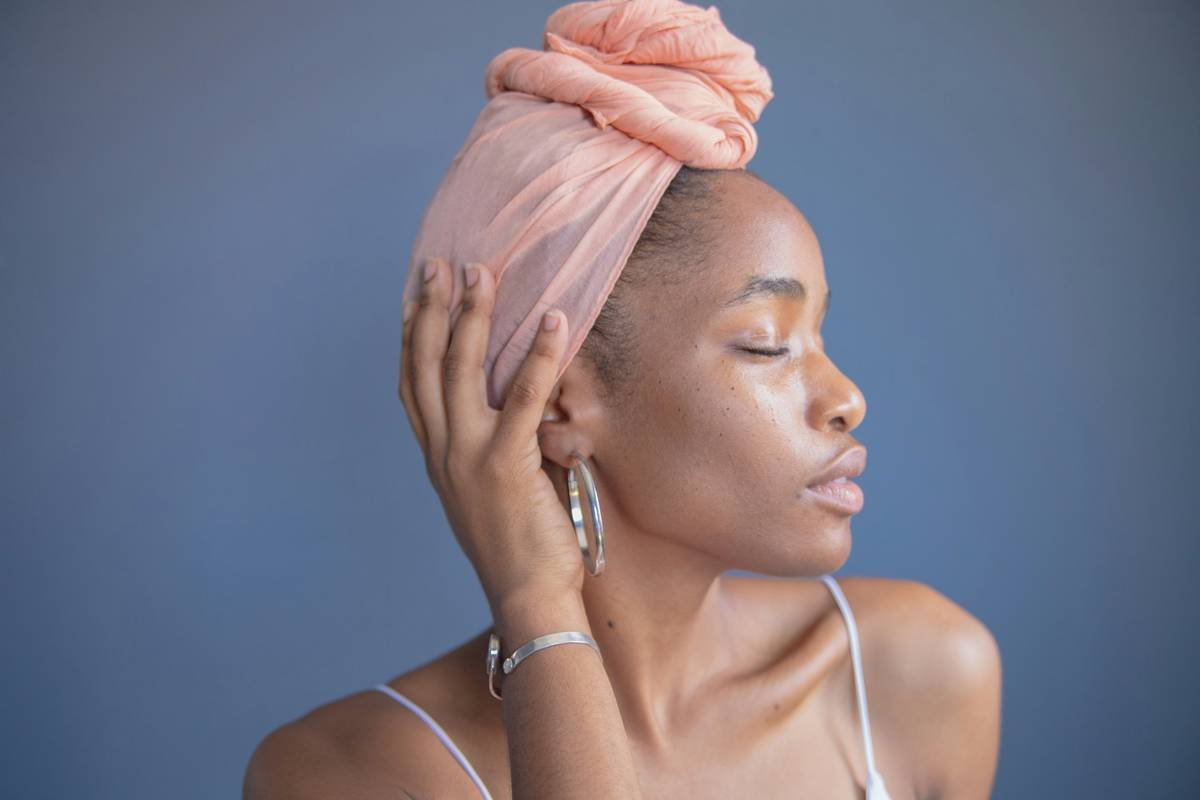 Side-by-side comparison of silk, satin, and cotton hair wraps showing smoothness and drape quality