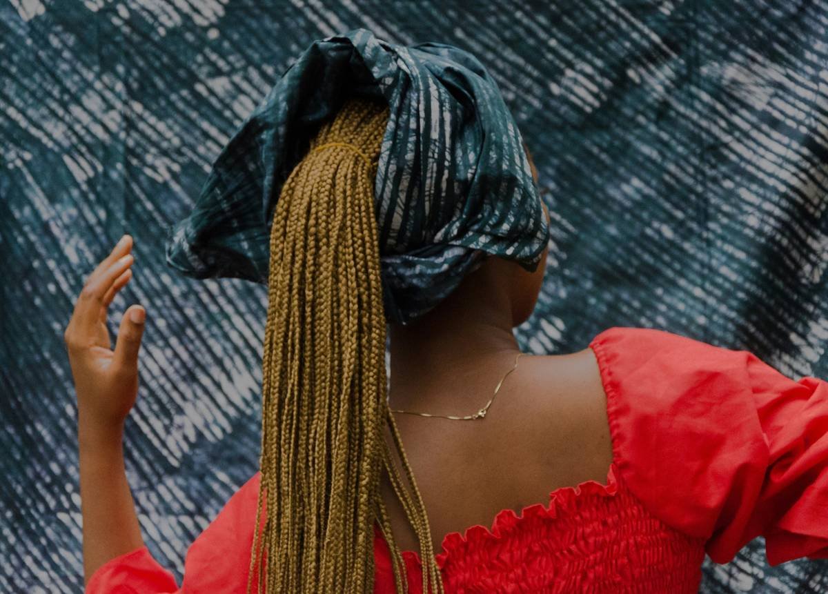 woman in red dress with blue and yellow scarf