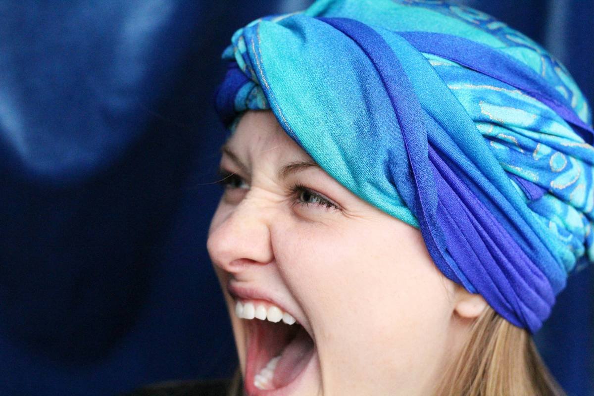 woman with blue hijab smiling