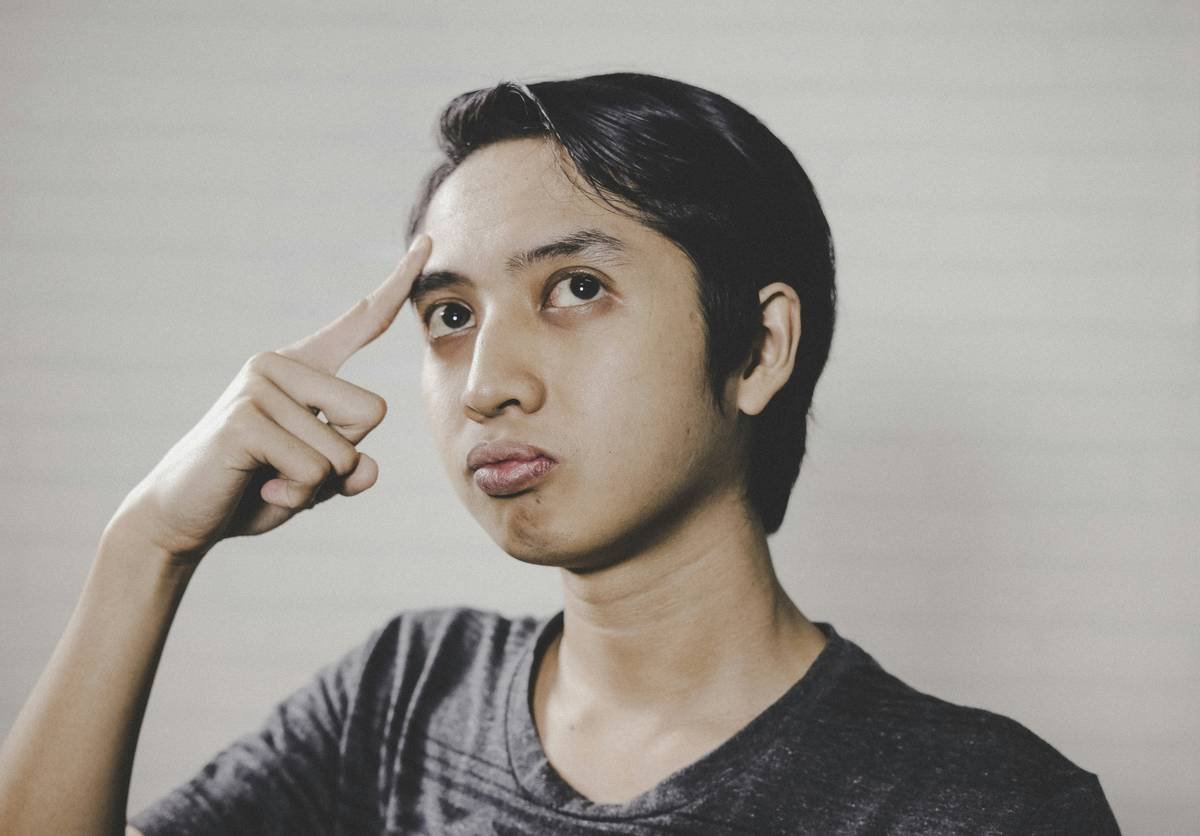 good looking south east asia man thinking