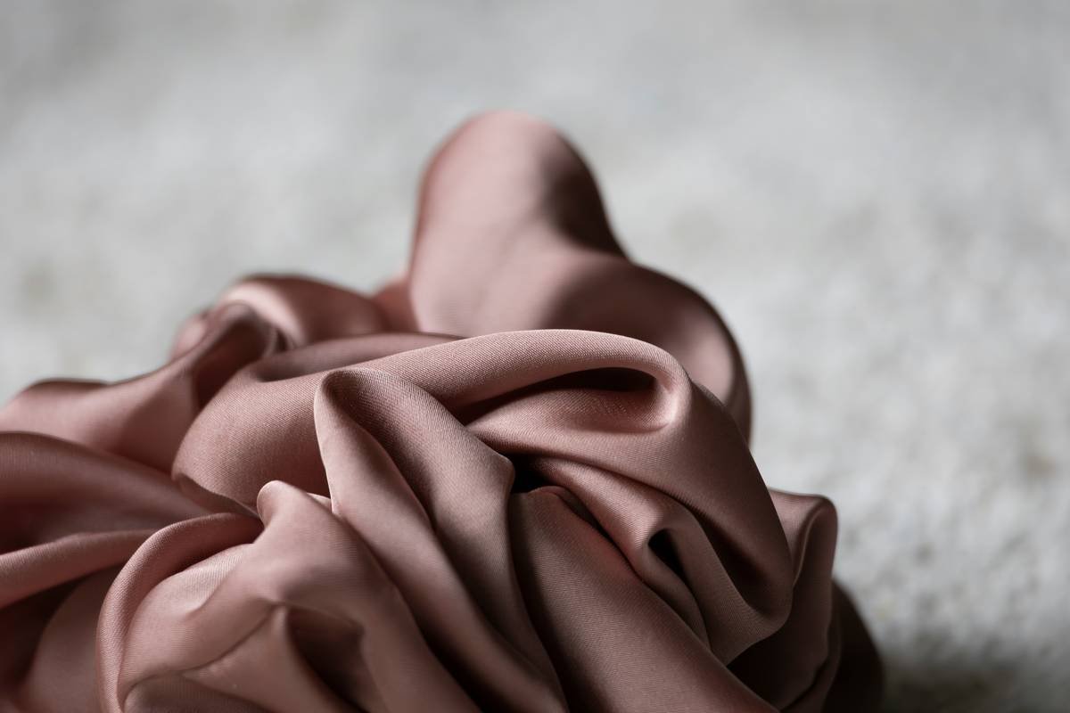 Pink fabric is artfully draped.