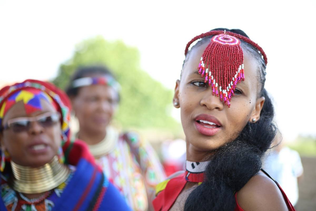woman wearing red beaded headdress