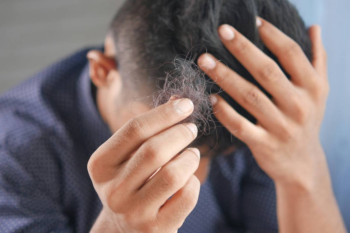 Woman using a high-quality sleep hair wrap made of mulberry silk to protect curls overnight